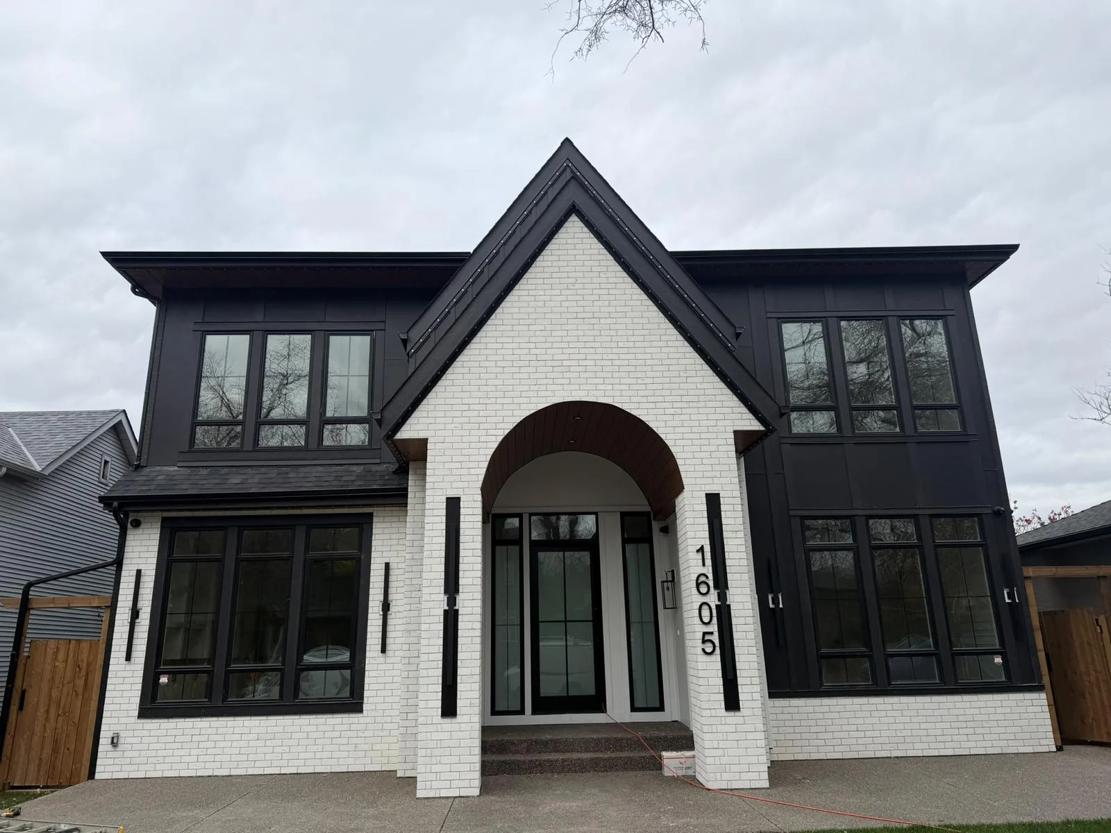 White masonry entrance and charcoal exterior cladding