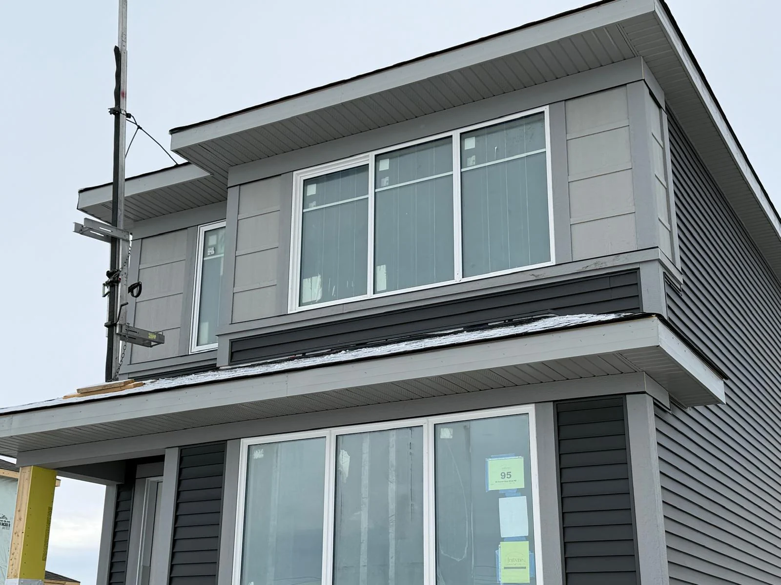 Mixed panel and horizontal siding with white soffit