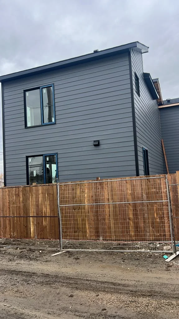 Side elevation with grey horizontal siding